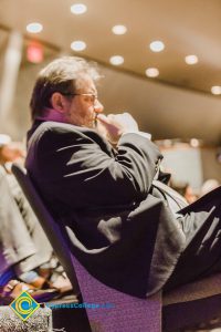 A gentleman sitting and listening intently at the Yom HaShoah event.