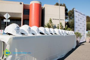 A table with a row of white hard hats.