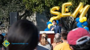 Man in a blue suit speaking to audience at the SEM Groundbreaking ceremony.