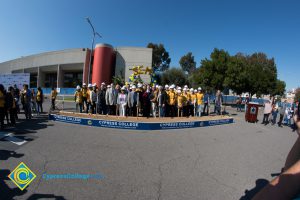 Group of people standing near shovels and dirt display box during SEM Groundbreaking ceremony.