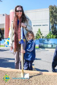 Woman and child at the SEM Groundbreaking dirt box.