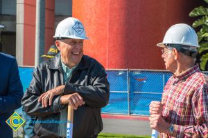 Two men in hard hats laughing.