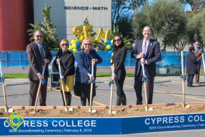 Fred Williams, Dr. Cheryl Marshall, Kai Stearns, Dr. JoAnna Schilling and Greg Schultz with shovels in the dirt box.