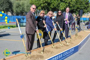 Fred Williams, Dr. Cheryl Marshall, Kai Stearns, Dr. JoAnna Schilling and Greg Schultz with shovels in the dirt box.