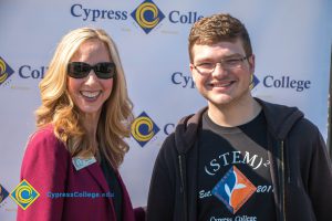 Woman with blond hair and sunglasses with a STEM² student.