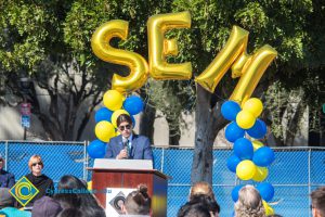 Man in a blue suit speaking to audience at the SEM Groundbreaking ceremony.