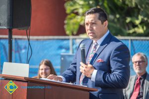 Man in a blue suit speaking to audience at the SEM Groundbreaking ceremony.