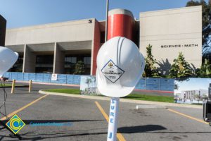 Science & Math building with white hard hats on stands in the foreground.