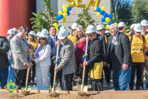 Staff shoveling dirt at the SEM Groundbreaking ceremony.