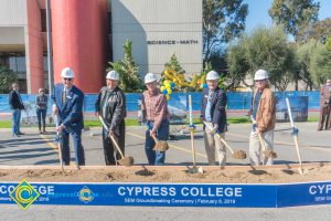 Staff shoveling dirt at the SEM Groundbreaking ceremony.