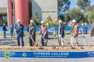 Staff shoveling dirt at the SEM Groundbreaking ceremony.