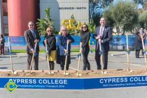 Staff shoveling dirt at the SEM Groundbreaking ceremony.