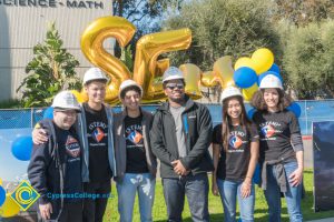 STEM² students wearing white hard hats.