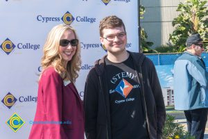 Woman with blond hair and sunglasses with a STEM² student.