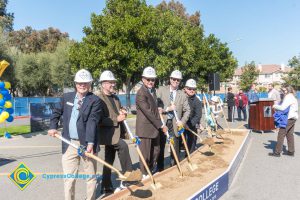 Staff shoveling dirt at the SEM Groundbreaking ceremony.