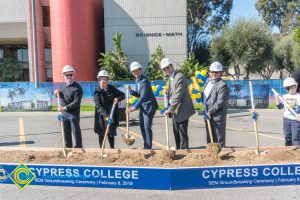 Staff shoveling dirt at the SEM Groundbreaking ceremony.