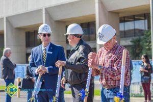 Three men in white hard hats.