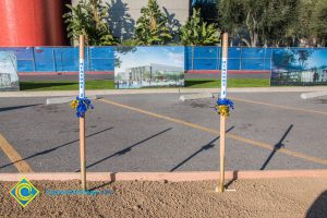 Two shovels in the dirt with ribbons and Measure J label.