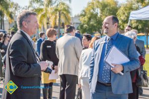 Marc Posner speaking with a man in a suit.