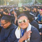 Cypress College graduates seated and focused on the commencement ceremony,