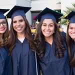 Four smiling young ladies in cap and gown.