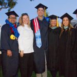 A smiling group of graduates with Culinary Arts instructors.