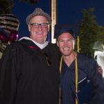 Bryan Seiling with a smiling graduate.