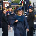 Smiling graduates after receiving degree during commencement,.