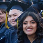 Smiling graduates during commencement ceremony.