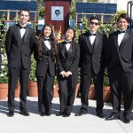 Dave Okawa with commencement ushers in black suits and bowtie.