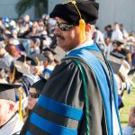 Santanu Bandyopadhyay, wearing sunglasses and full academic regalia during commencement.