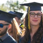 Smiling graduates during commencement ceremony.