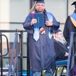 A graduate receives his degree at commencement.