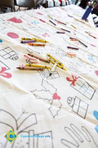 Coloring Christmas tablecloth with colored crayons and candy canes on it.