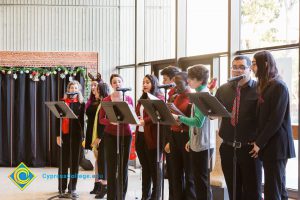 Group of students singing at the EOPS Holiday Celebration.