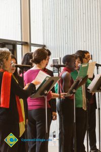 A group of singers at the microphone.