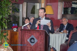 Cypress College Foundation Director, Howard Kummerman speaking into a microphone.