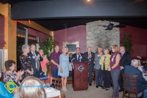 A group of people standing at the podium at the 2018 Americana Kickoff.