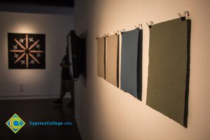 Various squares of colored fabric on display on the Art Gallery wall for the 100th Veteran's Day Anniversary.