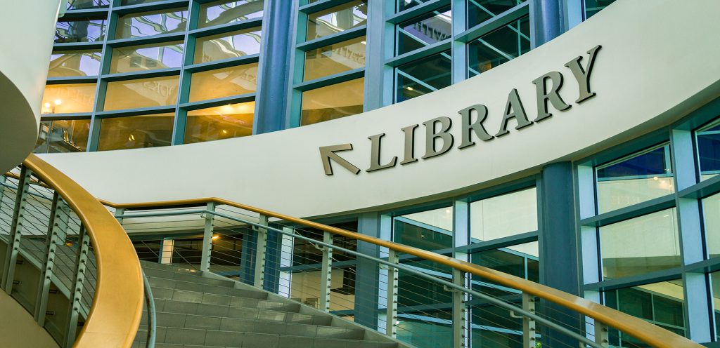 Inside of Library with arrow and sign that says "Library"