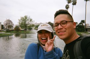 Students smiling by the pond,