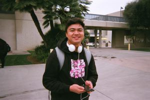 Student wearing black sweatshirt and white headphones