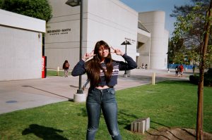 Student on campus giving peace signs
