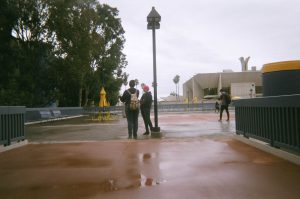 Two students standing under a light post on campus.