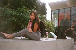 Young lady sitting on concrete seating area