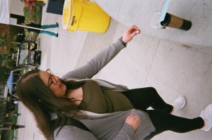 Student reaching for coffee cup