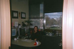 Woman smiling at her desk.