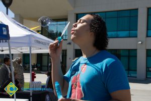 Male student blowing bubbles