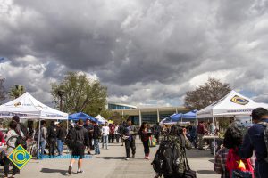 Students gathered at Club Rush event with dark clouds looming