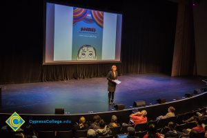 Dr. JoAnna Schilling speaking to an audience in the theater.